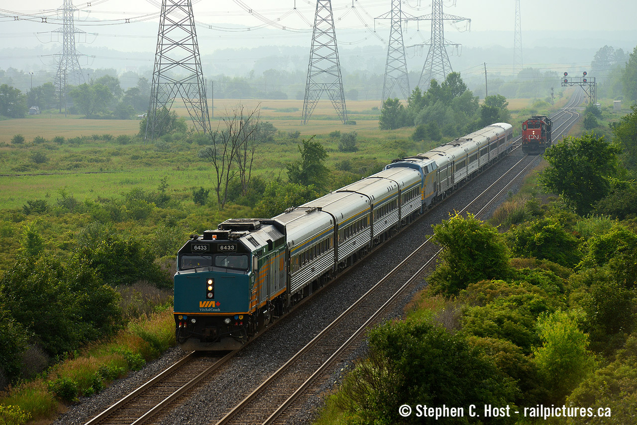 Rare Mileage for VIA Patrons as #75 and #79 combined travel over the normally freight only CNR Halton subdivision on a hazy, foggy day July 9 2013. Due to a washout on the Oakville sub VIA trains had to re-route. In the background is an aldershot-milton local servicing industries nearby and of course the hazy escarpment. We've been treated with VIA re-routes on the Halton sub about once a year ever since, plenty of time and opportunity to get this again. For the railway employees - would this train have required a CN pilot?