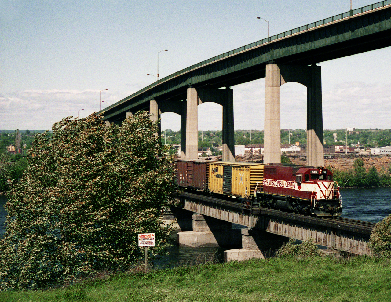 SDL39 589 with a transfer from Ontario heads back to Michigan crosses the main channel of the St. Mary's River and approaches the historic Canadian Canal