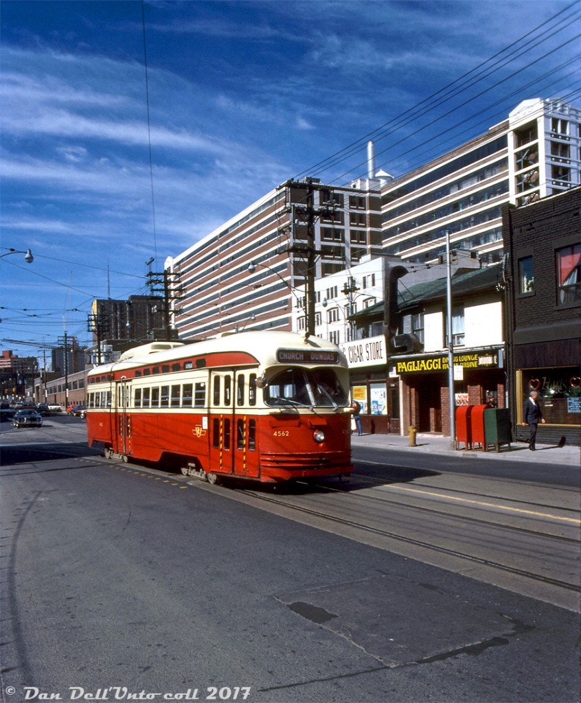 TTC PCC 4562, an A9-class car originally built for Cincinnati, operates on the Dundas route (via Church routing) coming off the curve heading southbound from Dundas Street onto Church Street. Towering in the background is the old Simpsons-Sears department store mail order building off Mutual St., still in use by Sears at the time but by the late 80's it had been sold off and is presently the "Merchandise Building" lofts. That long low building behind the streetcar has been demolished and is the present site of Ryerson's George Vari Engineering & Computing Centre building.

Original photographer unknown, Kodachrome from Dan Dell'Unto coll.