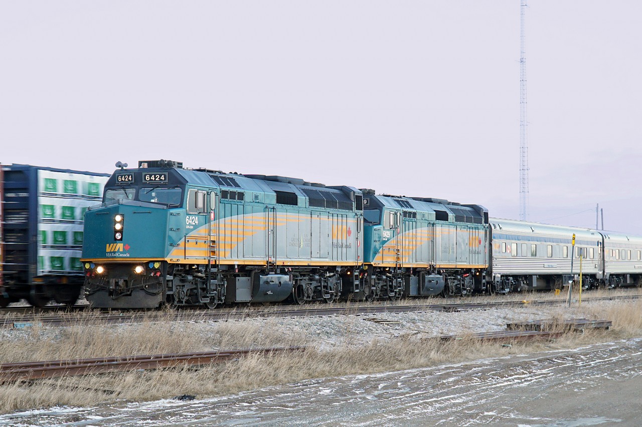 In the late afternoon light of a winterey Alberta day VIA #1 running about 10 hours late slowly rolls by a meet at Tofield.