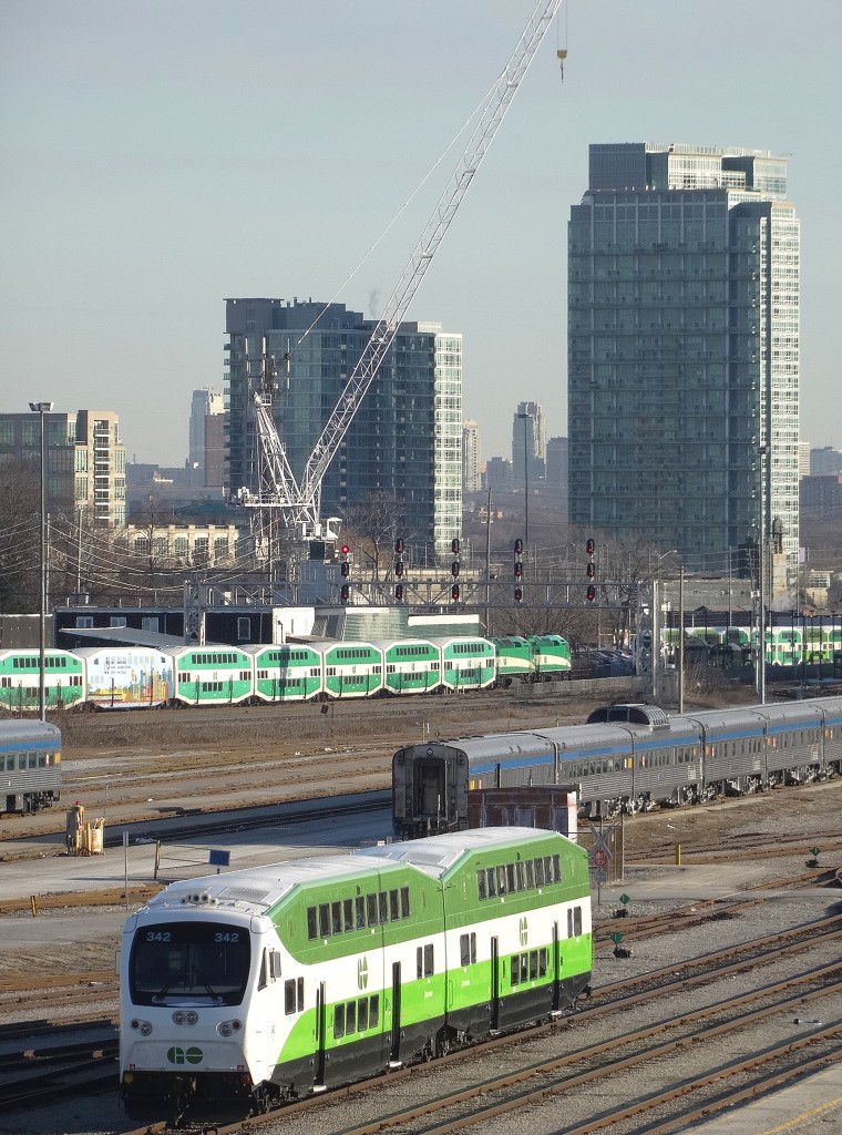 GO Transit CEM cab car in foreground with VIA passenger cars older GO Bi-level coaches and in background at the Willowbrook Yard in Mimico.