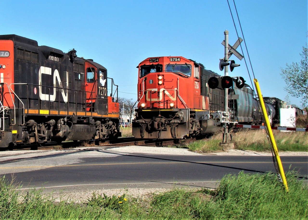 Here we see a meet between train 439 (at right) and a local freight at Howard Ave. on the CASO. I had begun chasing the local to Hiram Walkers (GP9, GP38 and 1 tank) as they left Van de Water Yard and planned to shoot him at Howard and other spots along the way. As I stood there taking my pictures I had no idea that 439 was approaching behind me, but as soon as I put my camera down I saw it coming and was lucky enough to get this shot off of the two passing by each other. 439 would almost always use the crossovers located about 10 cars back to access the yard, but on some occasions, like when a yard job needed headroom on the main, or in this case a local is working, they would stay on the south track and use the crossovers past Dougall Ave. The track 5754 is on is now out of service.