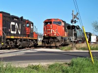 Here we see a meet between train 439 (at right) and a local freight at Howard Ave. on the CASO. I had begun chasing the local to Hiram Walkers (GP9, GP38 and 1 tank) as they left Van de Water Yard and planned to shoot him at Howard and other spots along the way. As I stood there taking my pictures I had no idea that 439 was approaching behind me, but as soon as I put my camera down I saw it coming and was lucky enough to get this shot off of the two passing by each other. 439 would almost always use the crossovers located about 10 cars back to access the yard, but on some occasions, like when a yard job needed headroom on the main, or in this case a local is working, they would stay on the south track and use the crossovers past Dougall Ave. The track 5754 is on is now out of service. 