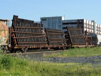 An interesting load of new pre-fabricated diverging track sections on a pair of CN MoW cars arriving on the afternoon inter-yard transfer from Aldershot to Oakville Yard.  Photographed just east of Oakville GO/VIA station; the multilevel parking garage looms in the background.  