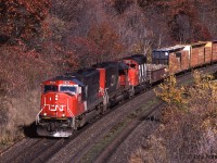 Clean 3 year old CN 5624 (SD70i) leads CN 5375 (EMD SD40-2, ex-UP) and CN 9674 (GP40-2w) on a westbound on the CN Oakville Sub departing Burlington ON.  Bayview Junction is a few tenths of a mile ahead.  Autumn is well advanced. <br> Nowadays there are 3 tracks here, but the trees have grown back vigorously and the new signal structure for Bayview Junction also gets in the way of pictures from Plains Road. 
