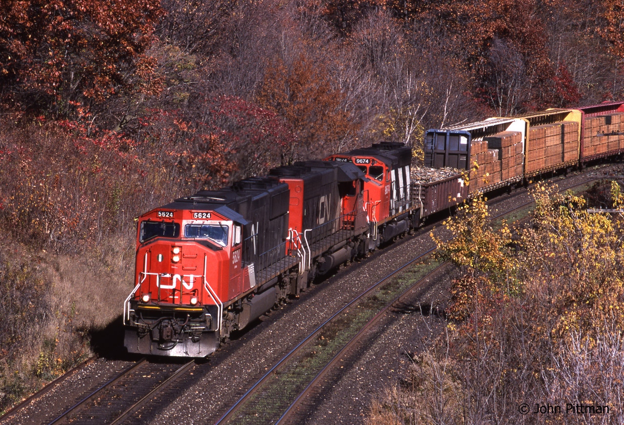 Clean 3 year old CN 5624 (SD70i) leads CN 5375 (EMD SD40-2, ex-UP) and CN 9674 (GP40-2w) on a westbound on the CN Oakville Sub departing Burlington ON.  Bayview Junction is a few tenths of a mile ahead.  Autumn is well advanced.  Nowadays there are 3 tracks here, but the trees have grown back vigorously and the new signal structure for Bayview Junction also gets in the way of pictures from Plains Road.