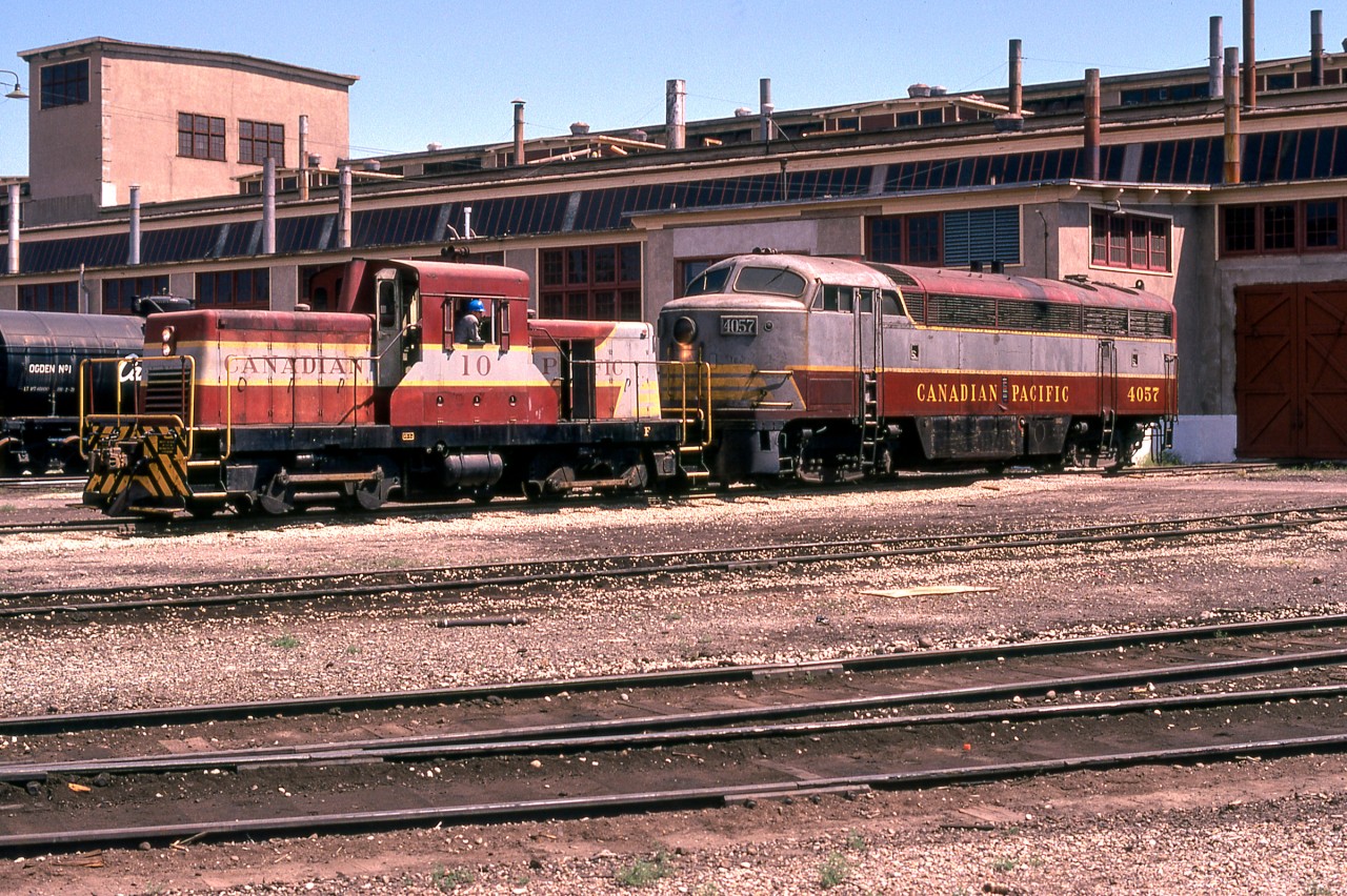 Merry Christmas to everyone on Railpictures.ca.
In late July 1974 I flew into Calgary for an overnight stay. After renting a car and driving to the CP yard where I received permission to take photos, I headed to the diesel shop. CP 10 (CLC DT-2) was moving CP 4057 (CLC CPA16-4). Within the space of about two minutes, a door opened up and 4057 was put inside. I was blessed to take this photo, and it is one of my favorites.