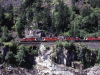 A west bound coal train headed for Roberts banks crosses just one of many stone viaducts near Hell,s Gate in the Fraser Canyon. 3 mid train helpers or slaves as known back then rounded off the power.  i had the exact location recorded, but time has misplaced it. if any one could help, please do. 
