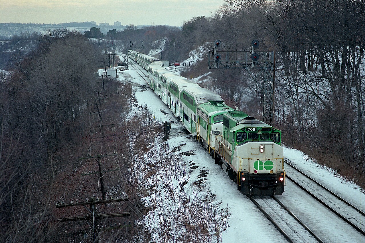 Five years ago I posted an image (#6753) of this train on the CP Hamilton Sub with an explanation. A derailment at Streetsville canceled most of the morning GO trains. Of 5, only two made it thru before the incident. A decision was made to run the others down from Guelph Jct, where they were kept at the time, to the CN and run along Lakeshore and back to Toronto to enable commuters that found other ways to Toronto in the morning, perhaps by auto or bus, to return to their homes at night in the manner they were accustomed. So there was this shocking scene of GO coming down from Waterdown.........the whole gaggle of GOs reversed out at Hamilton Jct and the GO 705 lead a three train set eastward, as seen here from the Bayview Walkbridge. As best I could tell all the power involved was GO 705, 906, 907, 710, 721, 904 and cab 239.  The Streetsville derailment was apparently of minor nature, and was to be cleaned up by later afternoon.