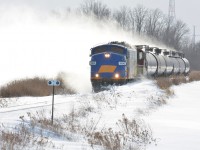 The St. Thomas Job passes through some drifts carved out earlier in the morning while kicking some wicked wind up from the drift built up since