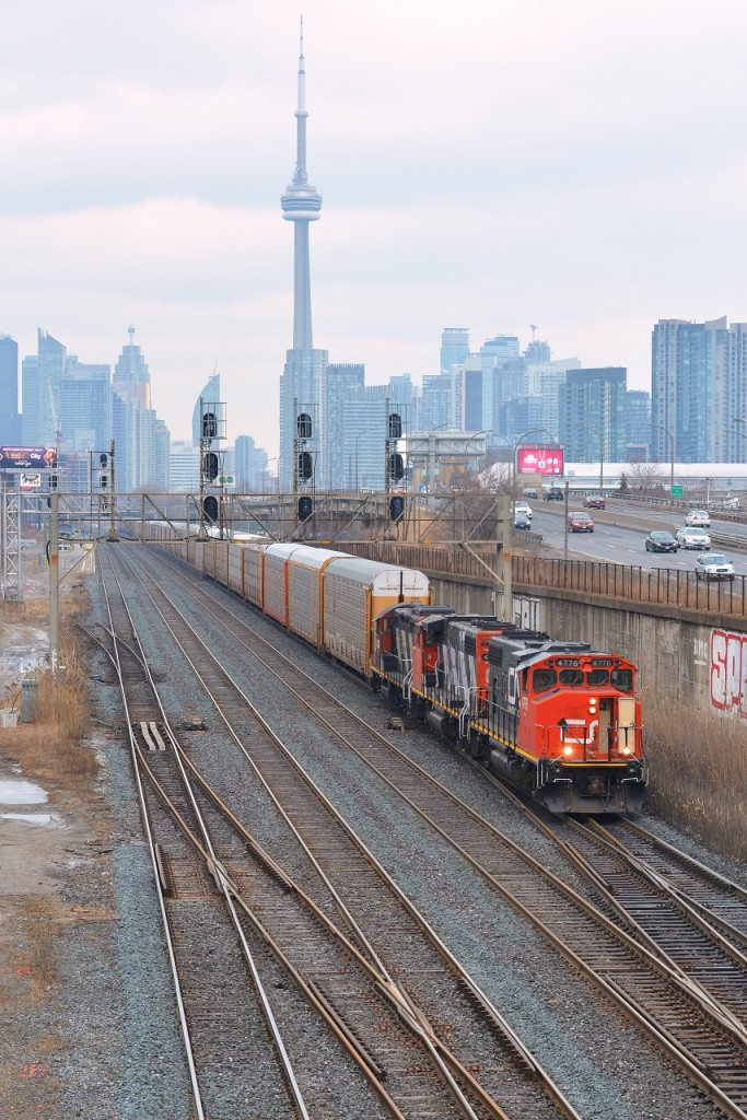 CN L570 is seen making a rare move through the Union Station Rail Corridor (USRC) pulling through the plant at Dufferin (Exhibition GO). Behind 4776, 4771, and 4114 are 88 empty racks bound for Oakville from Mac yard. Thanks for the heads up!