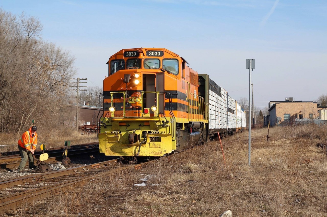 With their work complete in Guelph along with switching the Guelph North spurs, the engineer briefly steps down to close the switch off the mainline. Once the brakeman is back on board the train will begin its journey back to Cambridge. In the background is the former CN freight house and maintenance building now being redeveloped. Some of the old switches to the building are still intact.