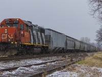Before the winter's first snowfall, dilapidated looking CN 4717 (still in Zebra stripes) pulls an unusually long string of cars on 514 into the siding of the former CSX yard. It is nudging it's nose just beyond one of the many historical concrete mile posts that still dot the line today.