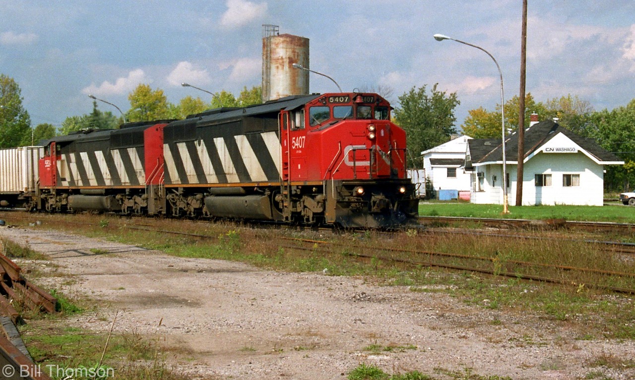 CN SD50F 5407 leads SD60F 5534 on a southbound freight, passing by the station in Washago in 2001.