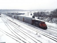 Ten years to the day after the Chessie System photo in Hamilton, we see the regular Oakville-Buffalo, NY auto train pass through a snowy "steel city". Generally, the power and crew would originate/terminate at MacMillan Yard and run light between there and Oakville Yard. Normal power was a single SD40u; however, occasionally a pair of GP40-2LWs would be used. In the 2000s, this train was renumbered 431 and ran with an SD75I or C44-9W.