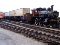 1950s technology meet 1910 technology. At the left we have an A-B-A set of CN F7 units (remanufactured in the 1970s) versus a 1910 built 2-6-0, one of an order for 25 built by the Canadian Locomotive Company for the Grand Trunk Railway. CN rostered 402 similar Mogul locomotives, some of which remained in service into the 1950s! The 91 was sold to a private collector in 1959, then the Ontario Science Centre, then another private collector, and eventually to the Middletown & Hummelstown Railroad in the State of Pennsylvania. It operated briefly in 1988 and was restored to service again in 2003. The railroad's web site states "Canadian National steam engine #91 Mogul 2-6-0 is out of service at this time." (Information from the Canadian Trackside Guide and Don McQueen's Canadian National Steam!) The photo shows the 91 passing through Hamilton around the time of its move to Pennyslvania.