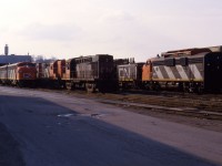 An interesting variety of power idles at the Stuart Street diesel shop in Hamilton. Visible are an A-B-A set of F7s led by the 9172; another F7A (9167); a pair of RS18s (3732 and 3701); a GP9; and SW1200RS 1350. Classic railroading in "the Hammer"!