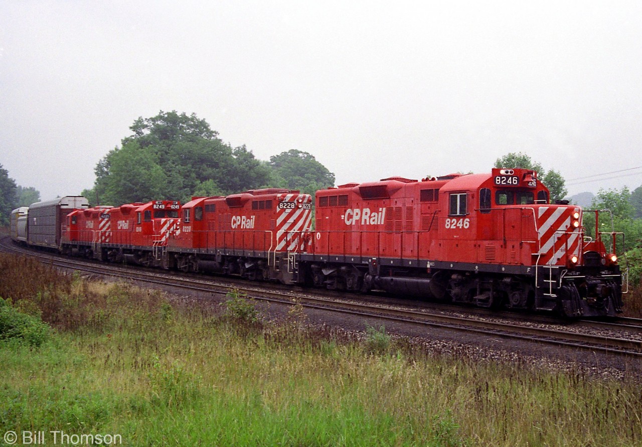 A westbound CP Rail freight from Toronto is seen approaching Bayview Junction on CN's Oakville Sub in July 1992. Rebuilt GP9u's 8246, 8238, 8249 & another 82xx handle the consist.

Today CP comes to Hamilton via Guelph Jct and the Hamilton Sub (former Goderich Sub), as CP's running rights agreement over CN's Oakville Sub had ended a few years ago.