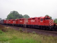 A westbound CP Rail freight from Toronto is seen approaching Bayview Junction on CN's Oakville Sub in July 1992. Rebuilt GP9u's 8246, 8228, 8249 & another 82xx handle the consist.<br><br>Today CP comes to Hamilton via Guelph Jct and the Hamilton Sub (former Goderich Sub), as CP's running rights agreement over CN's Oakville Sub had ended a few years ago.