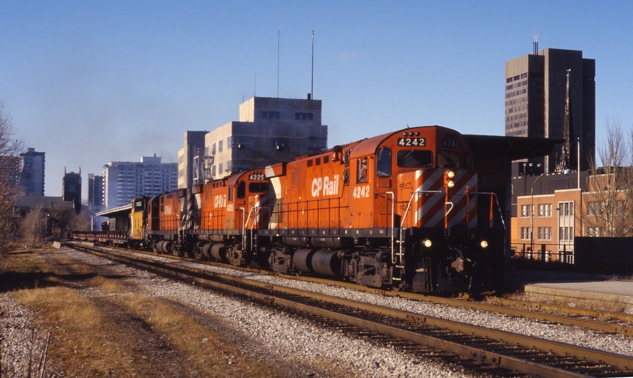 The collapse of the Cainsville fill on May 20, 1986 necessitated re-routing the steel train over the Welland sub. Here we see a trio of C424s leading it past the TH&B station in downtown Hamilton.