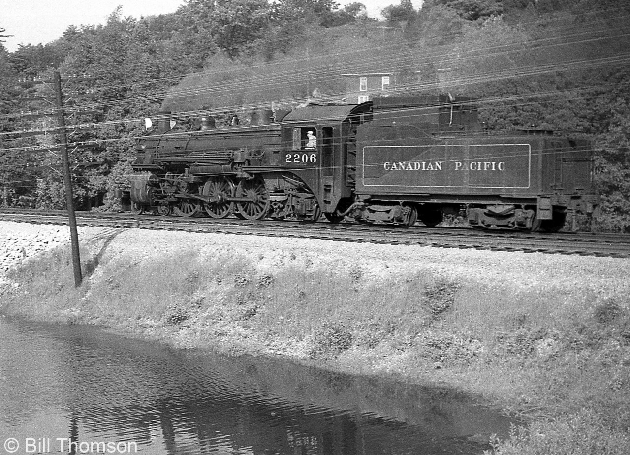 CPR G1 Pacific 2206 is seen passing through Campbellville by the pond, returning as a light engine to Lambton after making a push to Orr's Lake (assisting a westbound freight up the grade from Toronto) in August 1959.