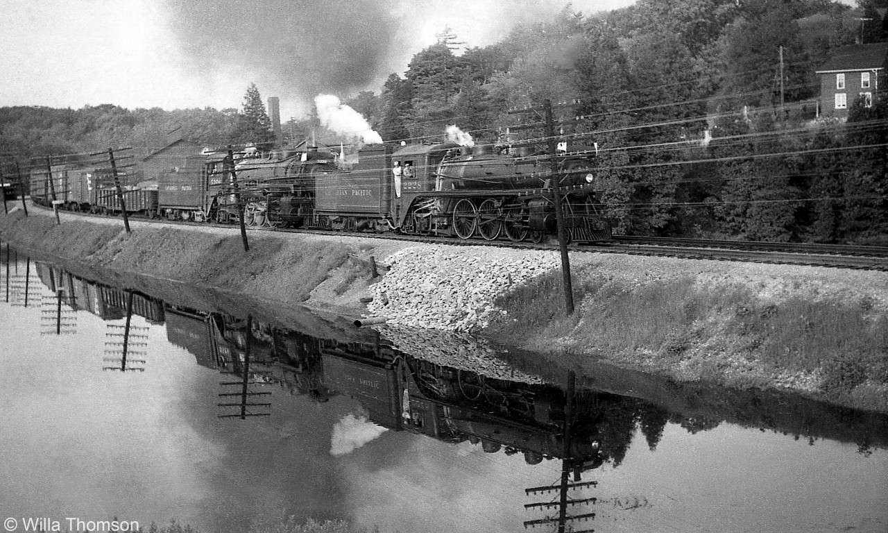 CPR G1 2228 (the assist engine) and P3 5370 head a westbound freight through Campbellville on the Galt Sub, past the pond that was smooth enough for a nice reflection. This photo was taken by my wife Willa (while I was taking a movie).