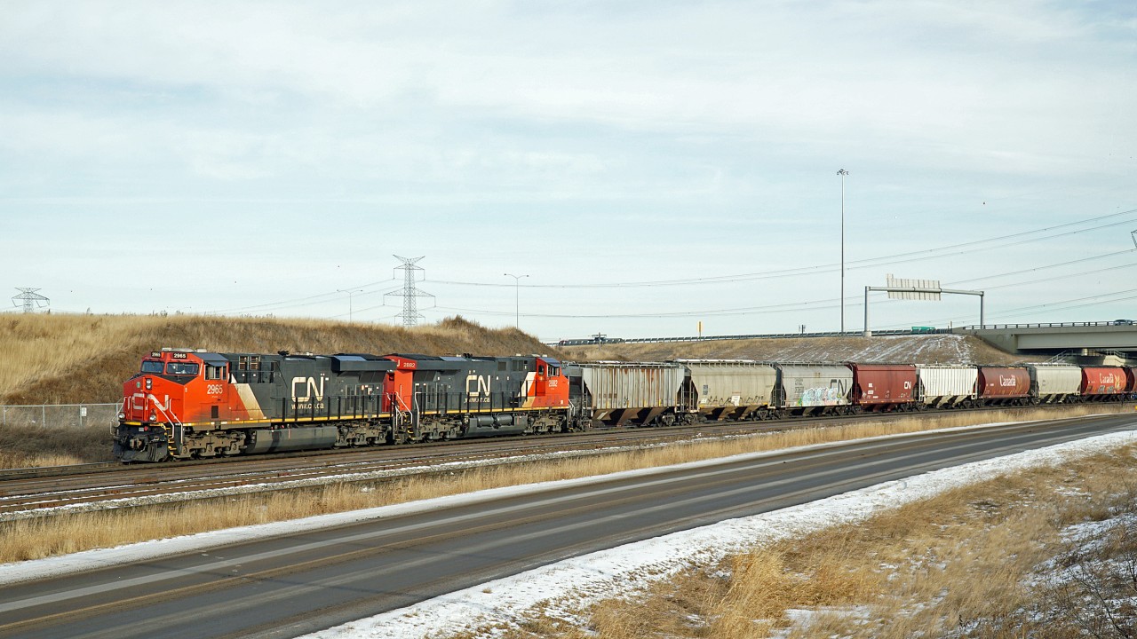 A pair of ES44ACs, CN 2965 and 2882 wait for clearance to cross the North Saskatchewan River bridge and proceed on to Edmonton.