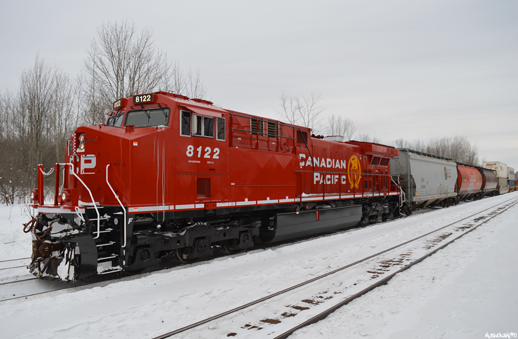 CP 8122 North creeps up the siding at Medonte with train 119 after meeting counterpart 118. CP 8122 is an AC4400CWM formerly CP 9628, and sports the sharp new "Modern Beaver" look on her first trip West after being released from GE in Texas over the last couple weeks.