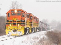 A very late running RLHH 595 approaches Third Line in Hagersville Ontario with the newest unit on the SOR roster on the point.  RLHH 2111, RLHH 3404, RLHH 3403 had 52 cars on the drawbar as they crawled through the snow and a 10mph slow order.