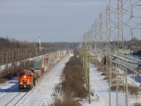 CN X121 has CN 2959 leading and CN 2334 51 platforms back as it heads west on CN's Kingston Sub with 130 platforms, including 81 empties.