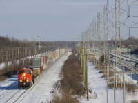 CN X121 has CN 2959 leading and CN 2334 51 platforms back as it heads west on CN's Kingston Sub with 130 platforms, including 81 empties.
