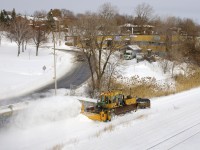A ballast regular set up as a snowfigher clears the transfer track of CN's Montreal Sub after a snowfall.