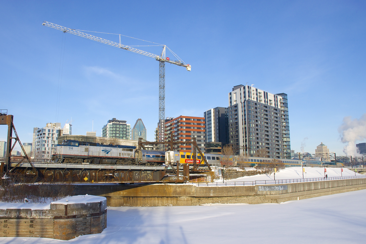 A close call! VIA 33 (shown here backing out, on its way to Ottawa) nearly blocked my shot of AMTK 514, surprisingly the power on the southbound Adirondack today. It is seen here deadheading to Central Station, with part of Montreal's skyline in the background.
