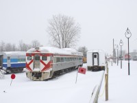 RDC-1 CP 9069 is surrounded by AMT 827 at left and ex-GO Transit coach AMT 1101 at right at Exporail just at the end of a massive snowstorm. At the right in the distance are a number of locomotives.