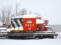 For sale at one point (in 2013), locomotive simulator 'CN 9633' is still on the property at Exporail, its current dispostion unknown. Here it is seen covered in snow after a snowfall of 36 centimetres (14 inches) had just ended in the Montreal area. Behind it is 70-tonner CN 30.