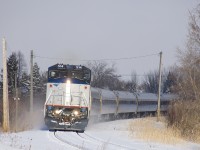 AMTK 68 with AMTK 514 leading rounds a curve in Brossard, approaching MP 36 of CN's Rouses Point Sub. Out of sight at left is the Massena Spur, now a line that serves a handful of local customers, but was once a through line to its namesake city of Massena, NY.