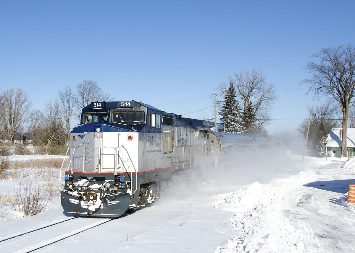 For the third time this week Dash8-32BWH AMTK 514 is leading the Adirondack on its way towards New York City. Here it passes through the small town of Saint-Blaise-sur-Richelieu.