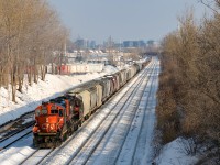 GP9's CN 7017 & CN 7228 are on their way to nearby Taschereau Yard with a mix of mostly empty grain cars and baretables (436 axles total) as they pass through Lachine during a brief sunny stretch this afternoon.