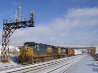 CSXT 5283, CSXT 4231 & CN 9574 are the power on a 42-car CN 327 which is seen passing through Dorval. The snow is completely covered in ice the day after Montreal got a lot of freezing rain, now frozen on a frigid afternoon.