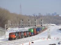 CN 149's power has just backed onto a cut of intermodal cars that had been left here by CN 121 the previous night. Soon the train will head west and add these cars to the head end of their train, which is waiting on the current main line. Due to massive infrastructure changes in the area, these tracks will become CN's new main line later on in the year, but for now these tracks are only used for block swapping or car storage. 
Power is a trio of SD75I’s (CN 5732, CN 5742 & CN 5673).
