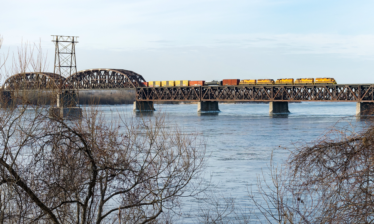 Detour SLR 394 is crossing over the St. Lawrence River on CP's Adirondack Sub, nearly onto the island of Montreal. Power is SLR 3004, QGRY 3102, SLR 3008, SLR 3804 & SLR 804.