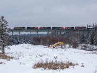 CN 2426 leads a mixed train across the Folly river heading west towards New Brunswick 