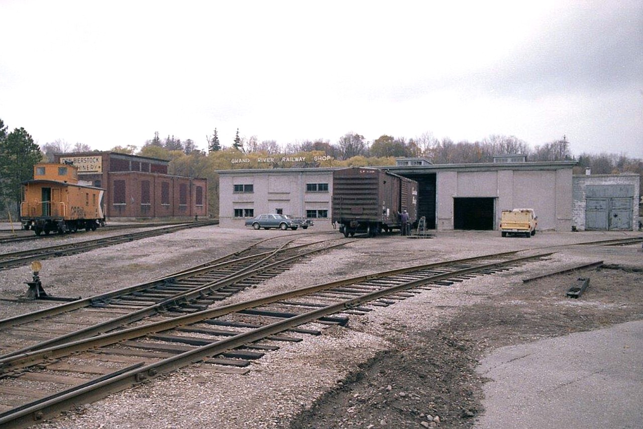 Here is a view of the old  GRNR shop, which was once the focal point for the maze of electric electric rail in the area. Since it was dieselized in late 1961, it was reduced to a car shop. On April 19, 1992 it was reduced to rubble after a major fire roared thru the premises, the roof collapsed, and the building was razed.