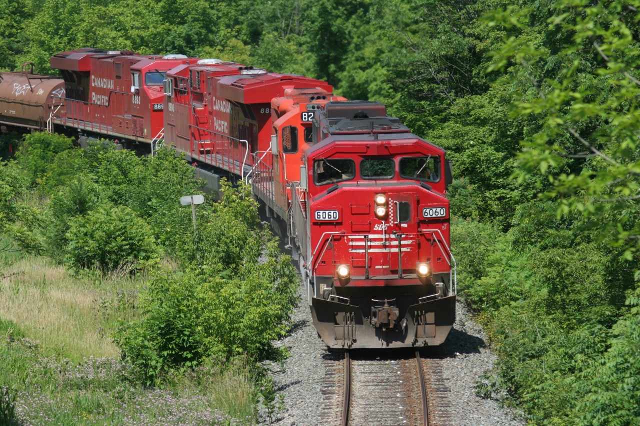 A southbound CP train is seen passing through Waterdown, Ontario has it continues its journey down the Hamilton Subdivision towards Hamilton and Welland on July 5, 2008. Powering the train are SOO Line SD60M 6060, GP9u 8229 and ES44AC’s 8896 and 8893.