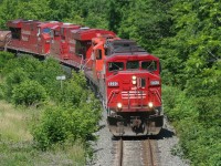 A southbound CP train is seen passing through Waterdown, Ontario has it continues its journey down the Hamilton Subdivision towards Hamilton and Welland on July 5, 2008. Powering the train are SOO Line SD60M 6060, GP9u 8229 and ES44AC’s 8896 and 8893. 
