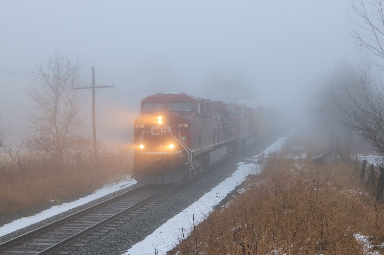 Out of the fog and drizzle comes CP651 with CP 8739 with CP 8800 leading just over 9000 feet of auto racks and tanker cars headed west cleared to Blandford.