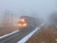 Out of the fog and drizzle comes CP651 with CP 8739 with CP 8800 leading just over 9000 feet of auto racks and tanker cars headed west cleared to Blandford.