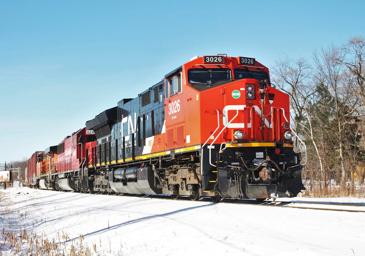 After getting a good soaker from falling through the snow covered ice, I was able to snap this shot of CP T-28 returning from a morning of interchange work with NS in Oakwood Yard in Detroit, MI. T-28 had a nice colourful lashup sporting paint from 3 of the 7 North American Class 1 railroads; CN, CP, and BNSF. In this picture, they are shoving their train into Windsor Yard. Windsor is a pretty inefficient area for CP as evident by a quick look on a maps website. The city is set up for ferry service and the tunnel was only really meant to be used by trains on the now defunct CASO Sub. Road trains that have work to do in Windsor Yard must make a cut at Dougall Ave, pull up to Lakeshore Jct (McDougall Ave), then shove on the original main into the yard. The same steps have to be done only in reverse on their way out of th e yard after finishing their work. Hopefully they'll figure something out in the near future to make Windsor a more efficient area on their network.