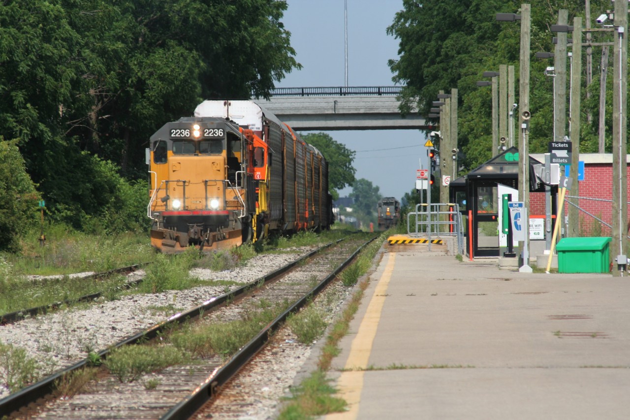 GEXR train 580 with LLPX GP38-2 2236 on the point is seen backing towards the yard in Kitchener, Ontario while GEXR train 431 is ready to depart on the main with QGRY SD40-3 6908 leading.