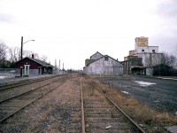 Here is a view looking roughly southward at the old Markham Village station. It is only in it's 4th month as a stop for the GO extension thru here. (Stouffville GO line)  This station was built in 1871 for the Toronto & Nipissing Rwy. Later taken over by GTR and then CNR.Passenger service dried up in the early 1970s. The station was saved from demolition when a millennium project between the City of Markham and the Markham Village Conservatory to purchase the old station and restore it came into being. The station is used for commercial purposes, as GO uses only the platform, not the station itself. It is a Heritage Building. I chose this image, rather than just the station itself, for Railpictures on account all the old structures other than the station are gone, replaced by housing projects and parking for around 250 cars. This scene is so rural in appearance compared to the present day.